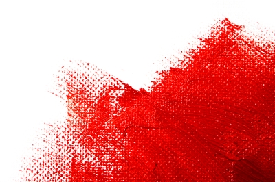 Close-up of red paint on white canvas
