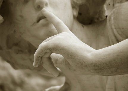 Statue holding finger to its lips