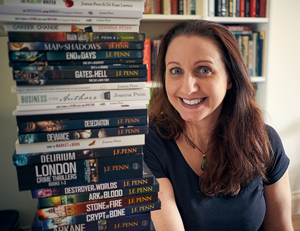 Photo of Joanna Penn with a stack of her books