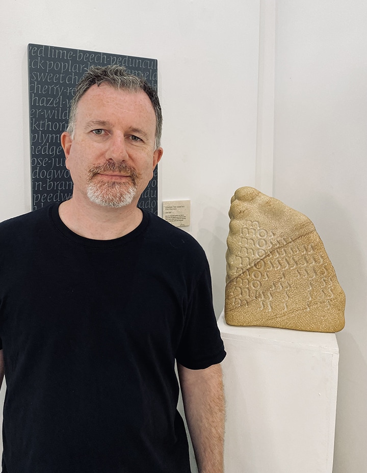 Mark McGuinness with Elegy for Moss poem sculpture co-created with Sheena Devitt