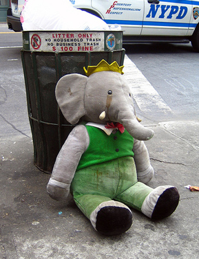 Toy Babar the Elephant abandoned next to a trashcan in New York City