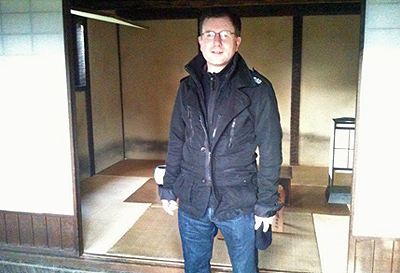 Mark standing outside a room in a Japanese house