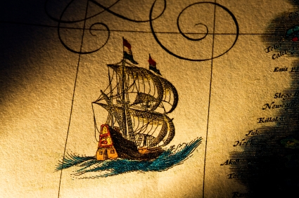 Ship sailing across antique map