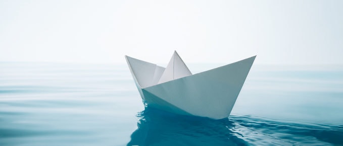 Paper boat on water