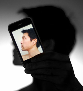 Silhouette of man with head replaced by iPhone.