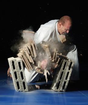 Karate master chopping through a stack of tiles