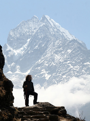 Mountaineer looking over stunning view from mountain path