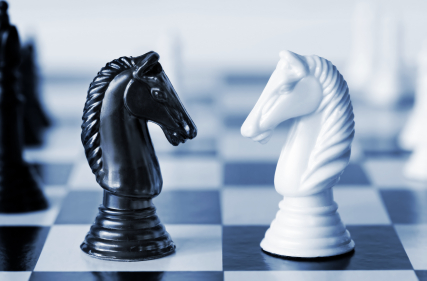 Two knights facing each other on a chessboard