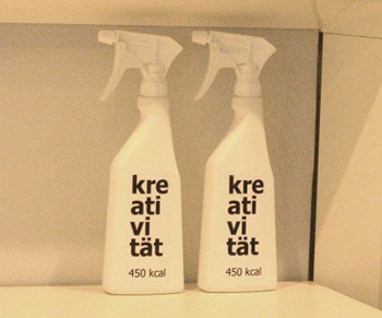 Two spray bottles with Kreativitat written on them