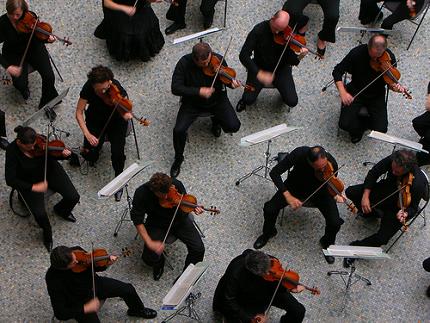 Violinists playing in an orchestra.