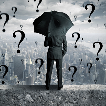 Man looking over city with question marks raining from sky
