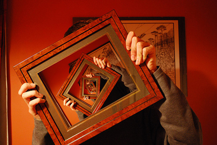 Man holding picture frame containing an image of the man holding a picture frame... ad infinitum