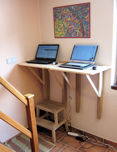 Two retractable wall-mounted desks for laptops